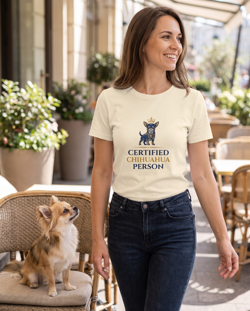 Woman wearing the Certified Chihuahua Person t-shirt on a cafe terrace with her chihuahua