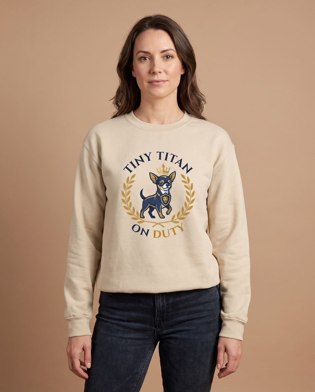 Woman wearing the Tiny Titan on Duty sand sweatshirt, front view studio shot